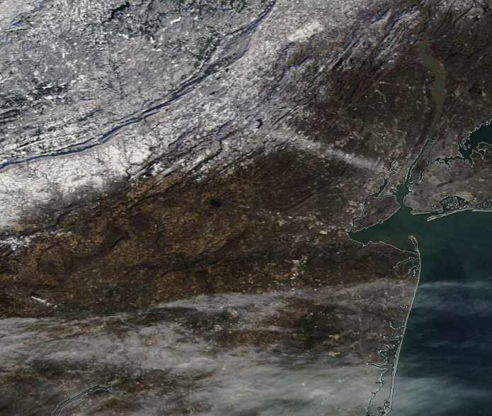 MODIS visible satellite image on the morning of December 12th. The previous evening’s squall path across north Jersey is seen compared to surrounding snow-free ground. Widespread snow cover is found to the northwest across northwest NJ, northeast PA, and part of NY. Cirrus clouds cover portions of South Jersey and southeast Pennsylvania (NASA).